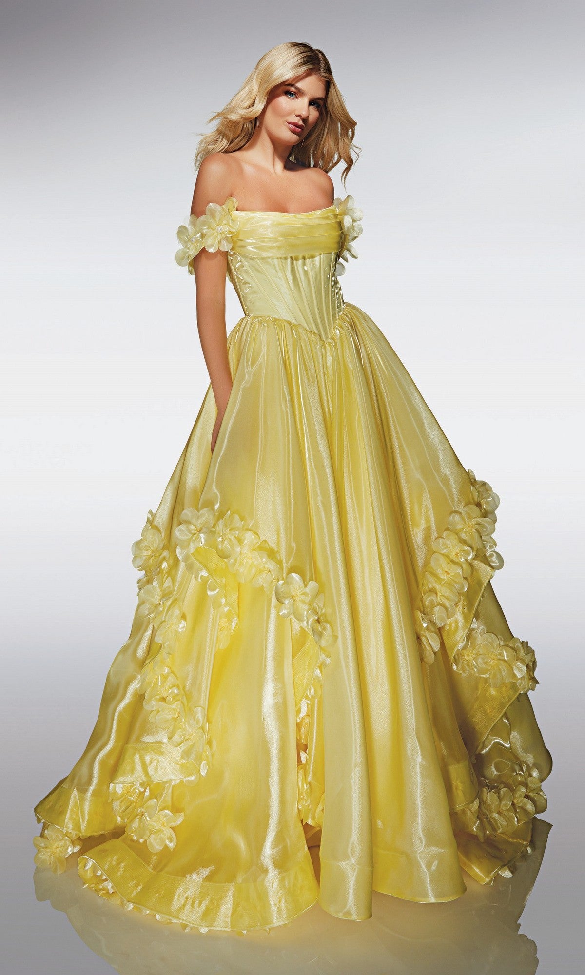 A woman models the Alyce 62014 Long Prom Dress, a shiny strapless ballgown with 3D floral appliques, in front of a plain light background.